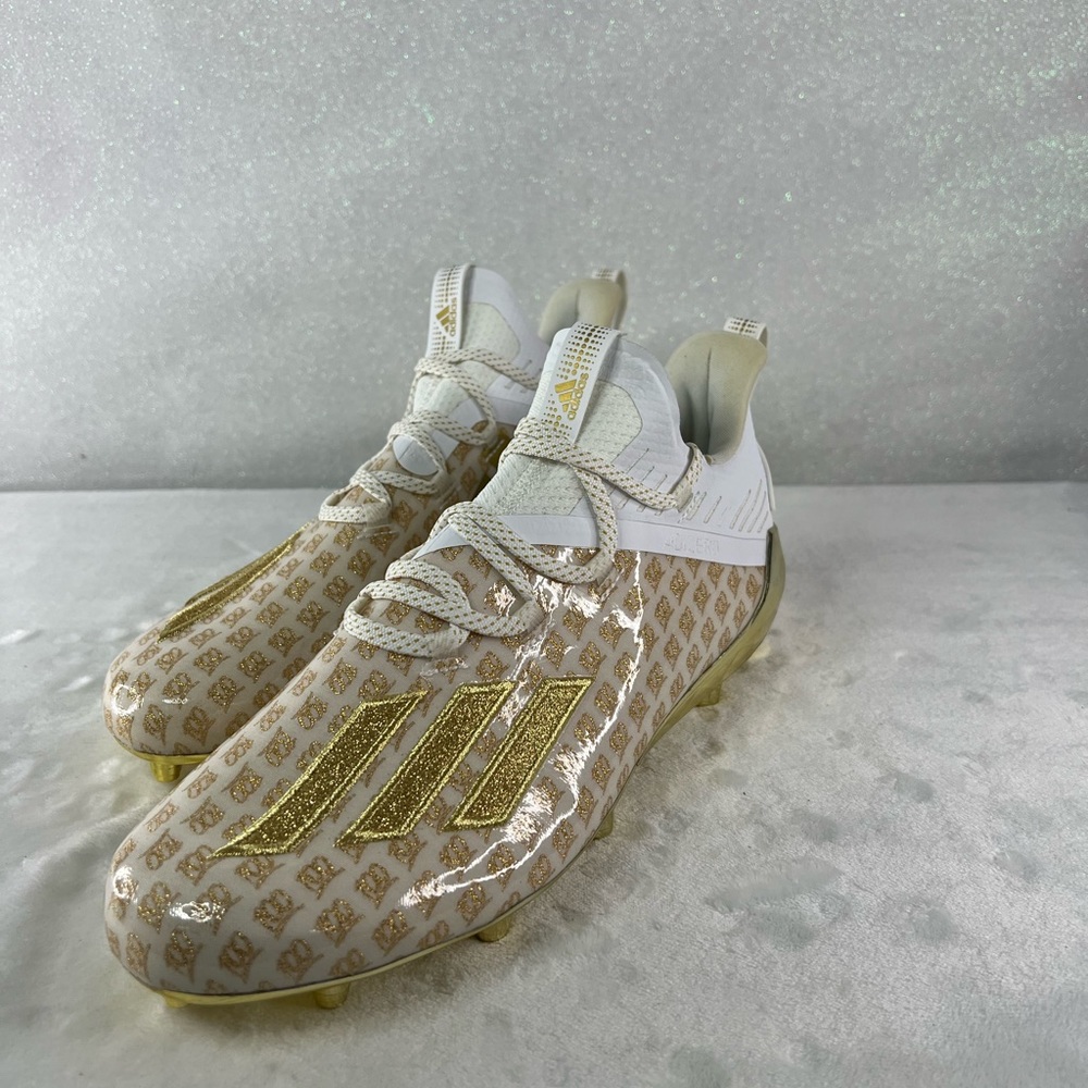 Size 9 1/2 white and gold football cleats